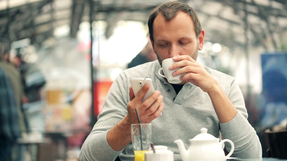 T-544667992ad05-stock-footage-man-texting-on-smartphone-and-drinking-tea-in-cafe_544667992ac41-2.jpg