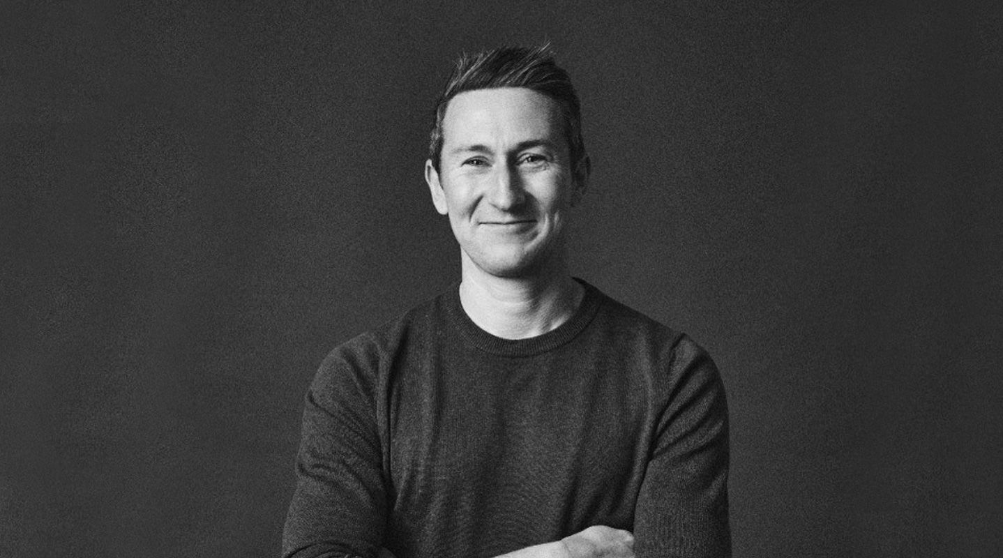 Man smiling with arms folded