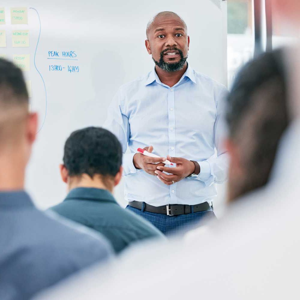 Man in front of white board