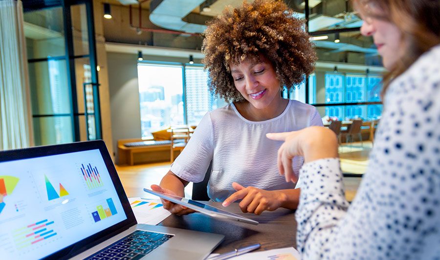 Two women in conversation over data