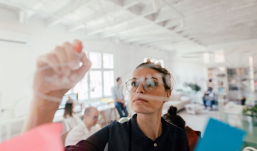 Women writing on whiteboard