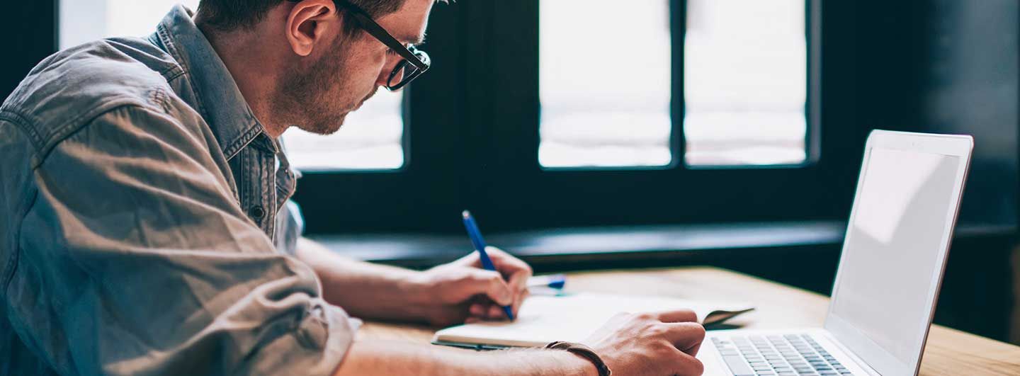 Man writing at computer