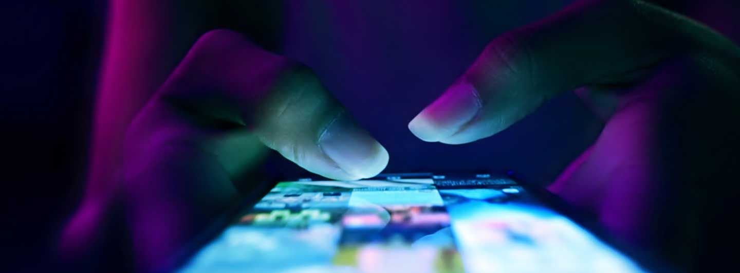 Fingers using a mobile phone