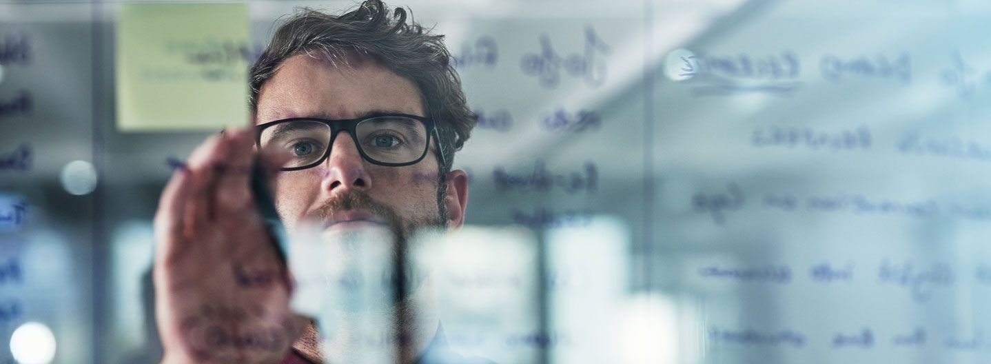 Man draawing on a board