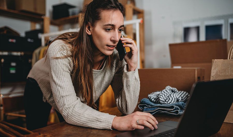 Woman on phone and laptop