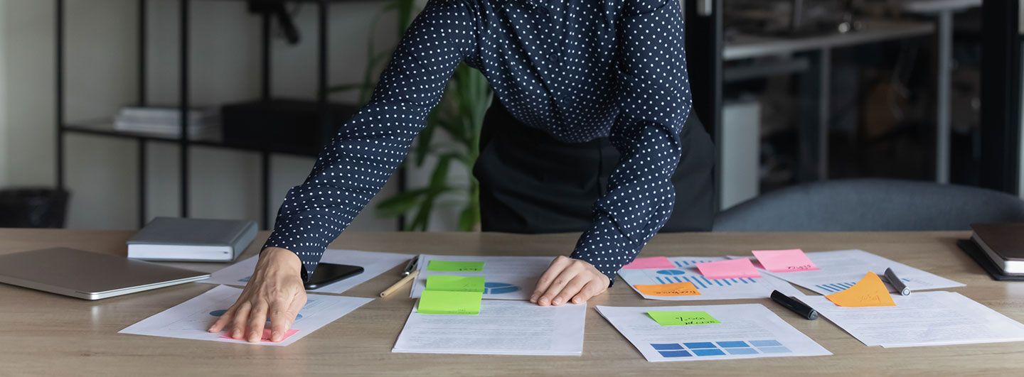 Hands moving paper and plans