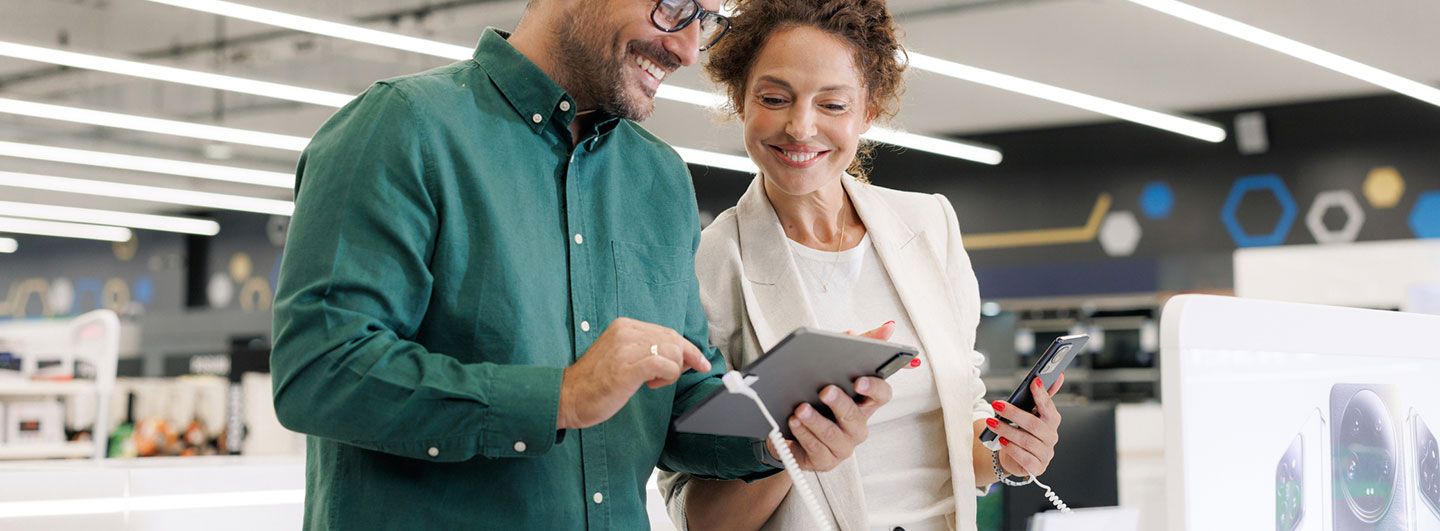 Two people smiling on tablet and phone