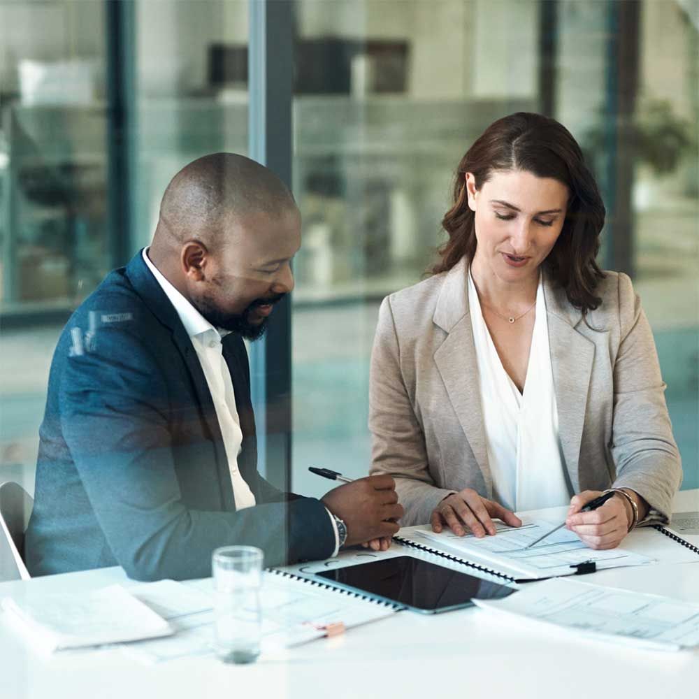 Two people discussing documents