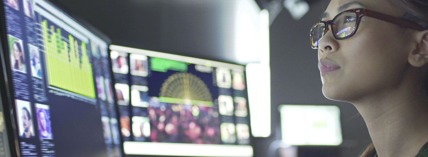 Woman looking at multiple screens